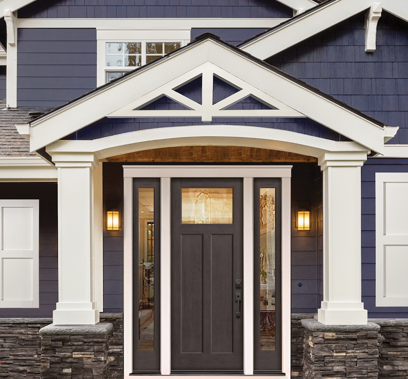 This blue-clad and stone home has a white Craftsman-style gable decoration above the entryway.