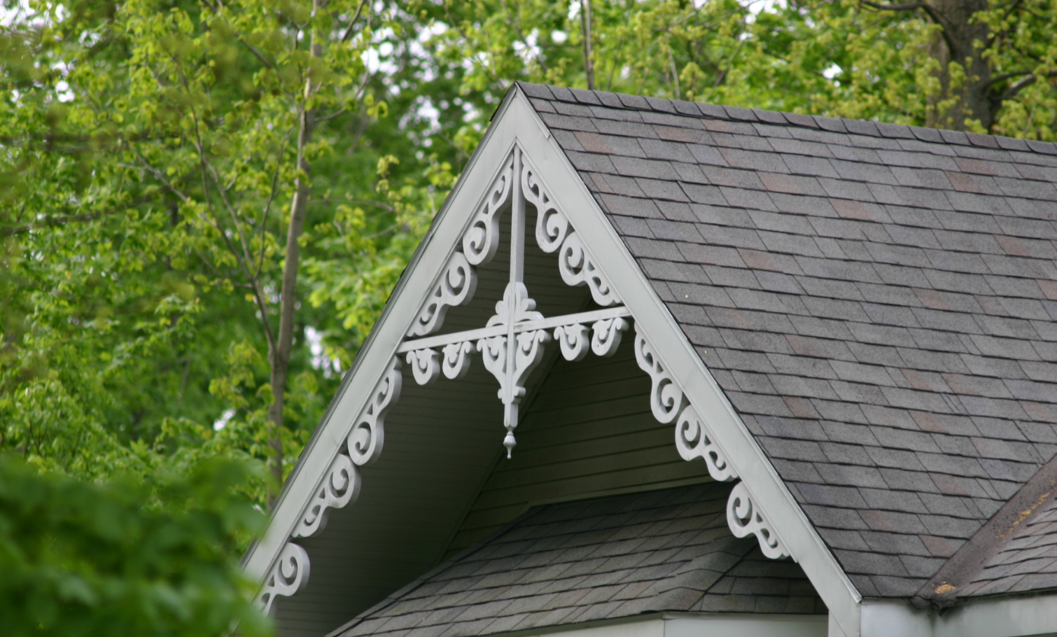 This close-up image shows a home’s gingerbread-style gable decoration.