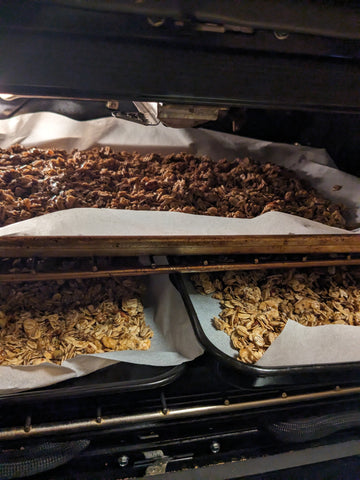 trays of gingerbread granola going in the oven