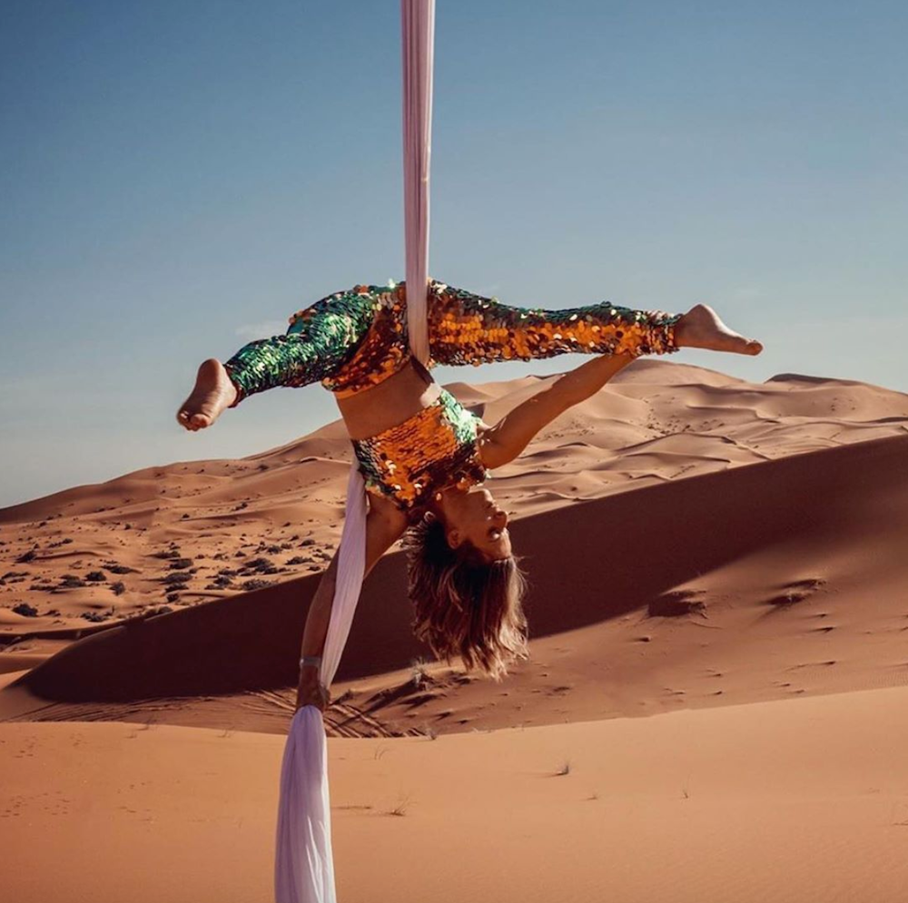 Aerial silks performer wearing sequins in the Sahara desert