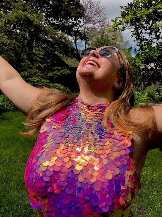 Elated woman wearing a pink sequin leotard