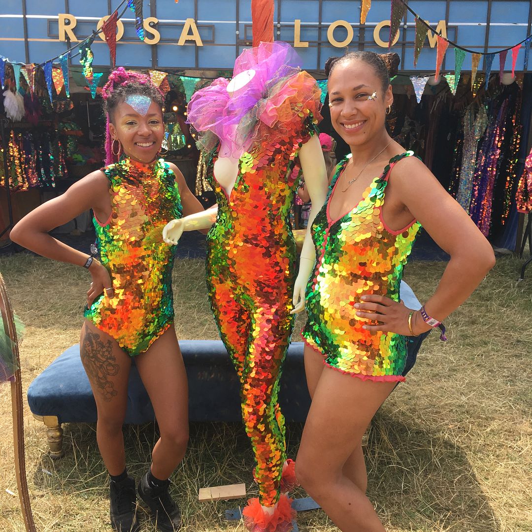 Festival goers wearinf sequin leotards pose with a mannequin