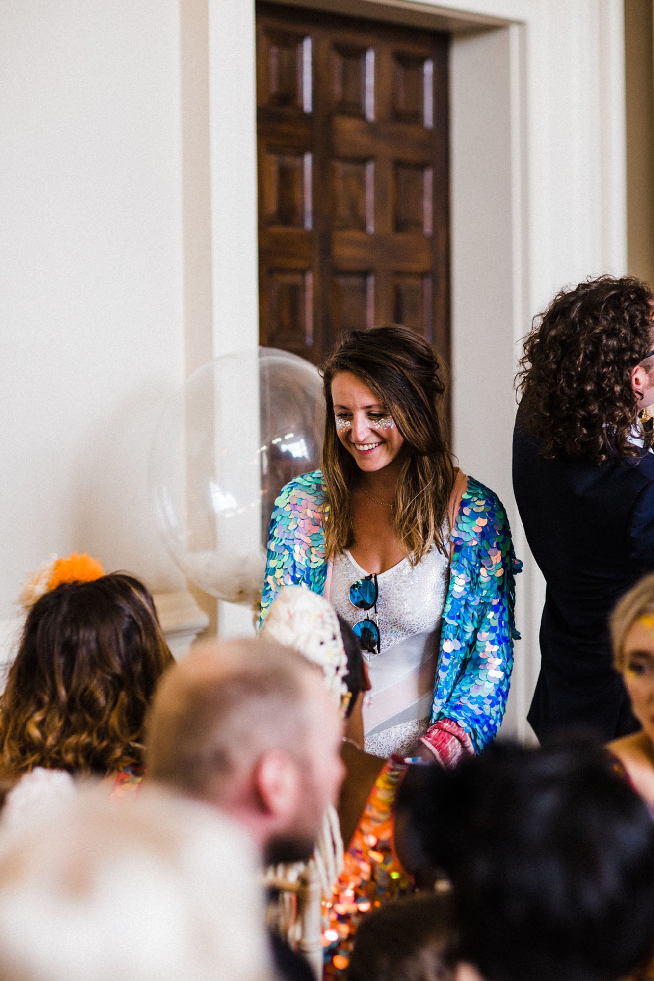 A festival fashion wedding guest arrives in a sequin kimono