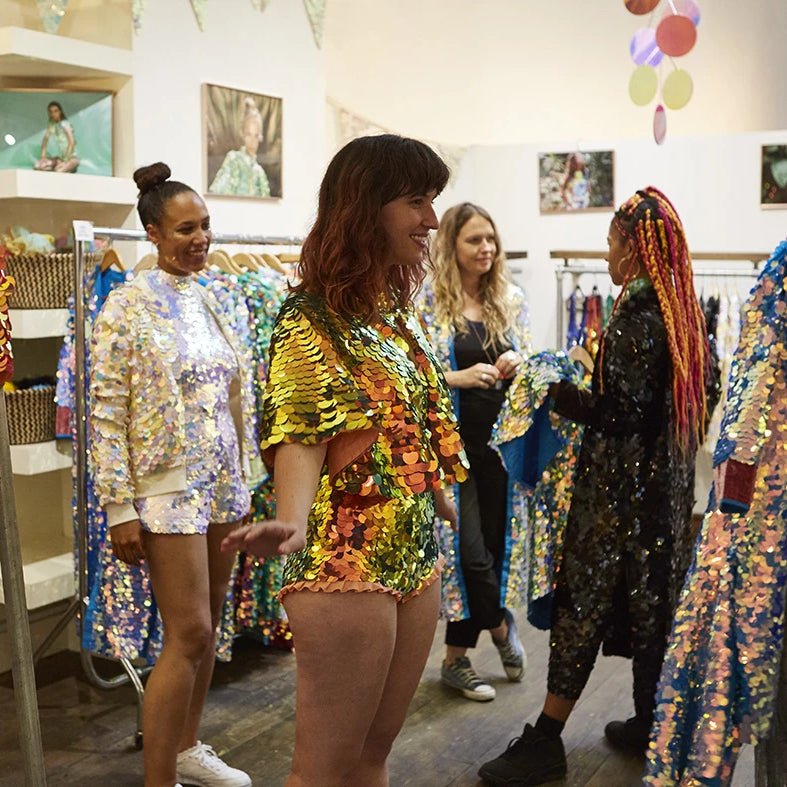 A shop customers admires her sequin outfit