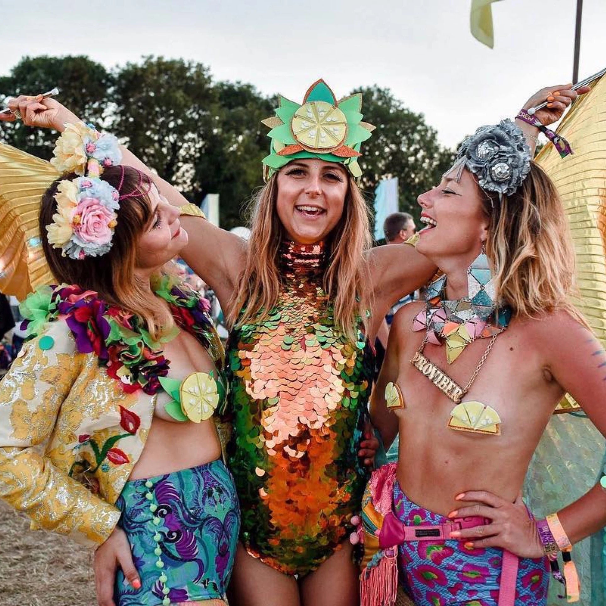 Three friends in sequin clothing at a festival