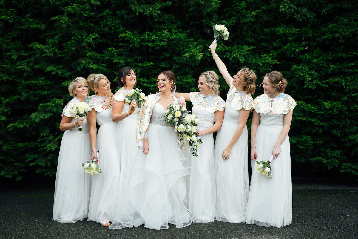 Six bridesmaids and a bride post in sequin capes