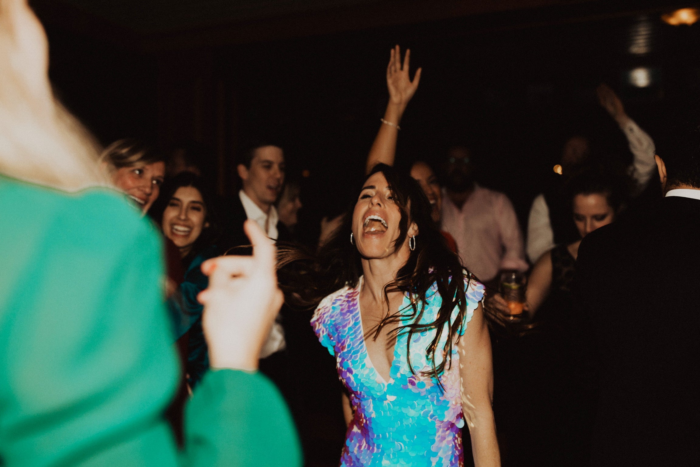 Woman sings on while on the dance floor at her wedding