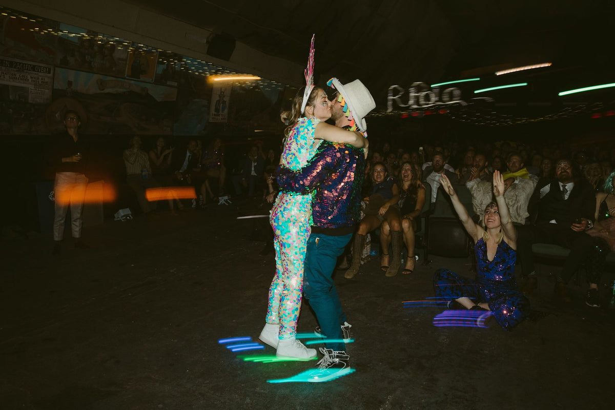 Bride and groom wearing sequin outfits at their festival wedding