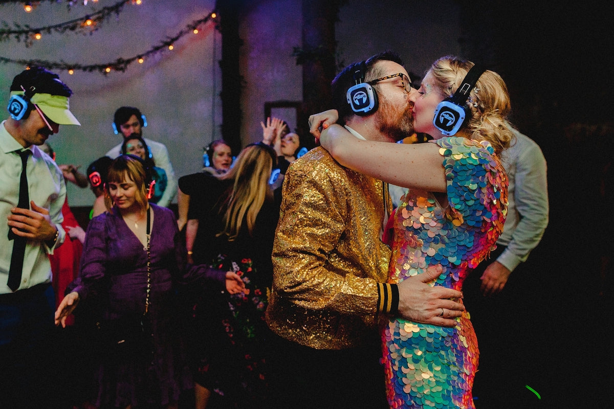 A bride and groom pictured in a warm embrace on the dance floor of their silent disco at their wedding reception. 