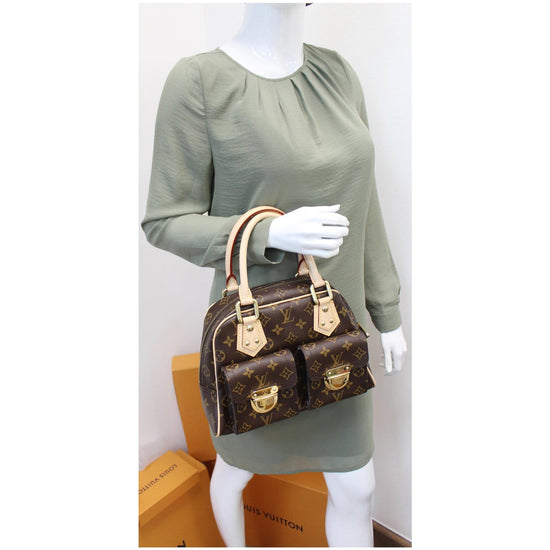 A Louis Vuitton monogram canvas Manhattan PM bag, the front with two  compartments with brass monogrammed