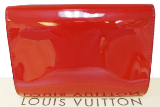 LOUIS VUITTON- Red patent leather bag in its pouch, circ…