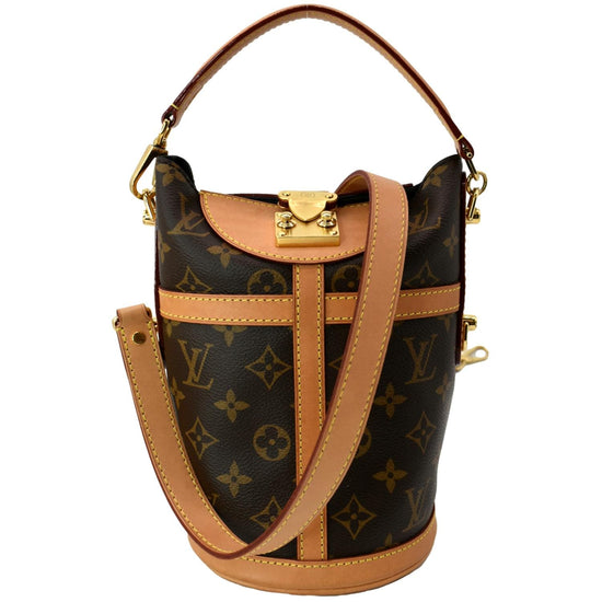 Louis vuitton bag with the brown and light brown monogram on one side, and  black and dark gray borders. made of leather and featuring a square shape  with the gold lv logo