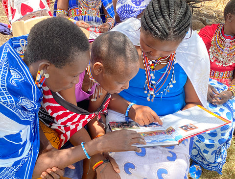 maasai ladies reading The Greatest Love Story Ever Told