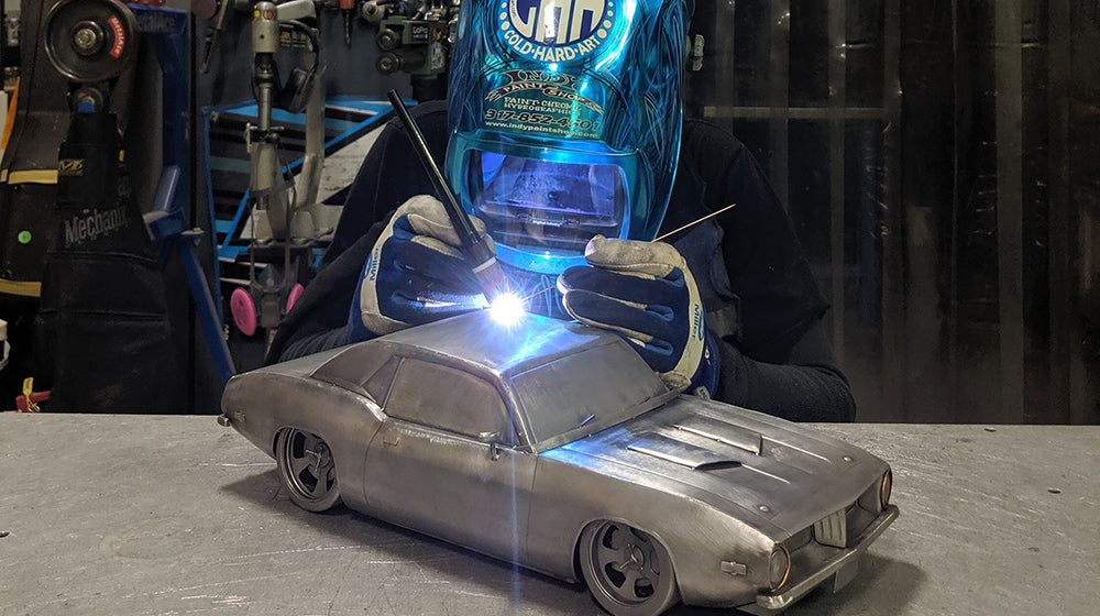 Tom Pastis welding a car together