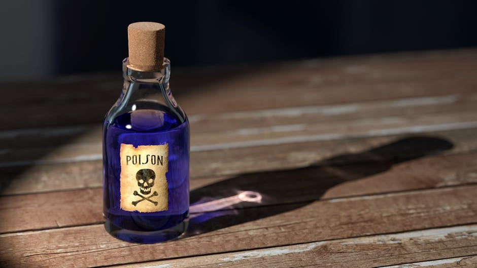 underarm-detox-purple-liquid-poison-glass-bottle-on-wood-floor