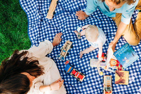 Mother, father and baby on a picnic blanket