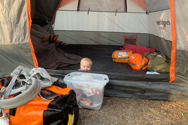 a toddler playing at a camp site