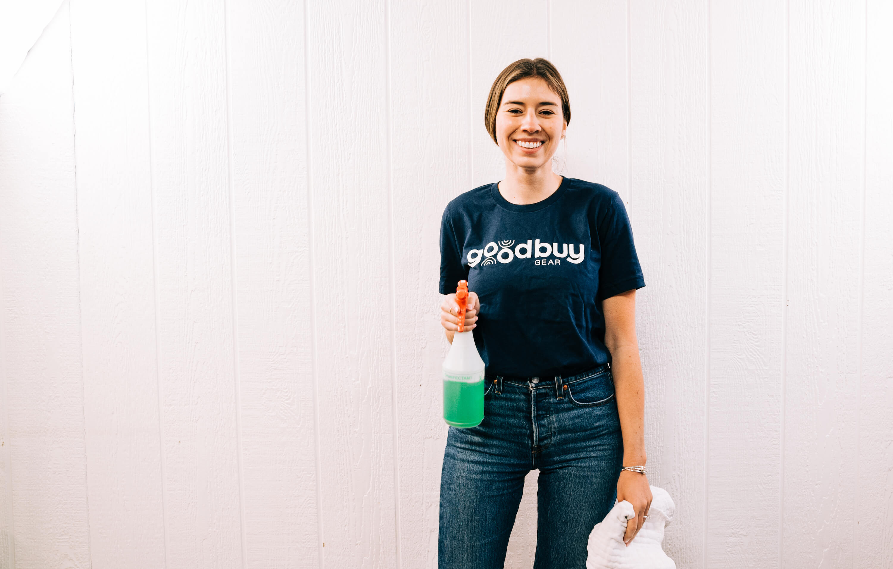 GoodBuy Gear's gear expert smiling and holding a bottle of cleaning solution 