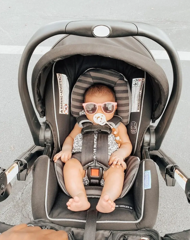 Baby in car seat stroller at Disney