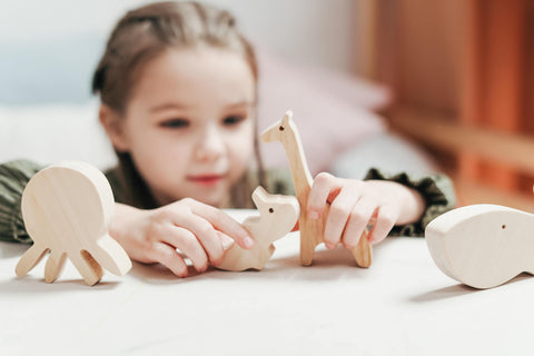 Child playing with wooden toys