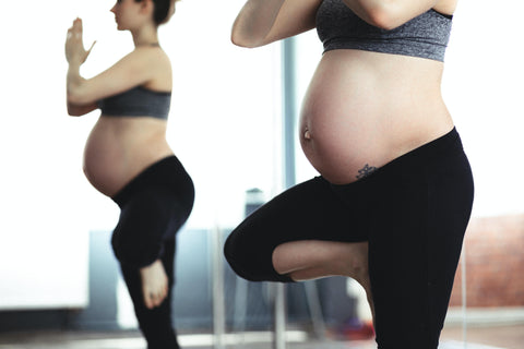 Woman practicing prenatal yoga