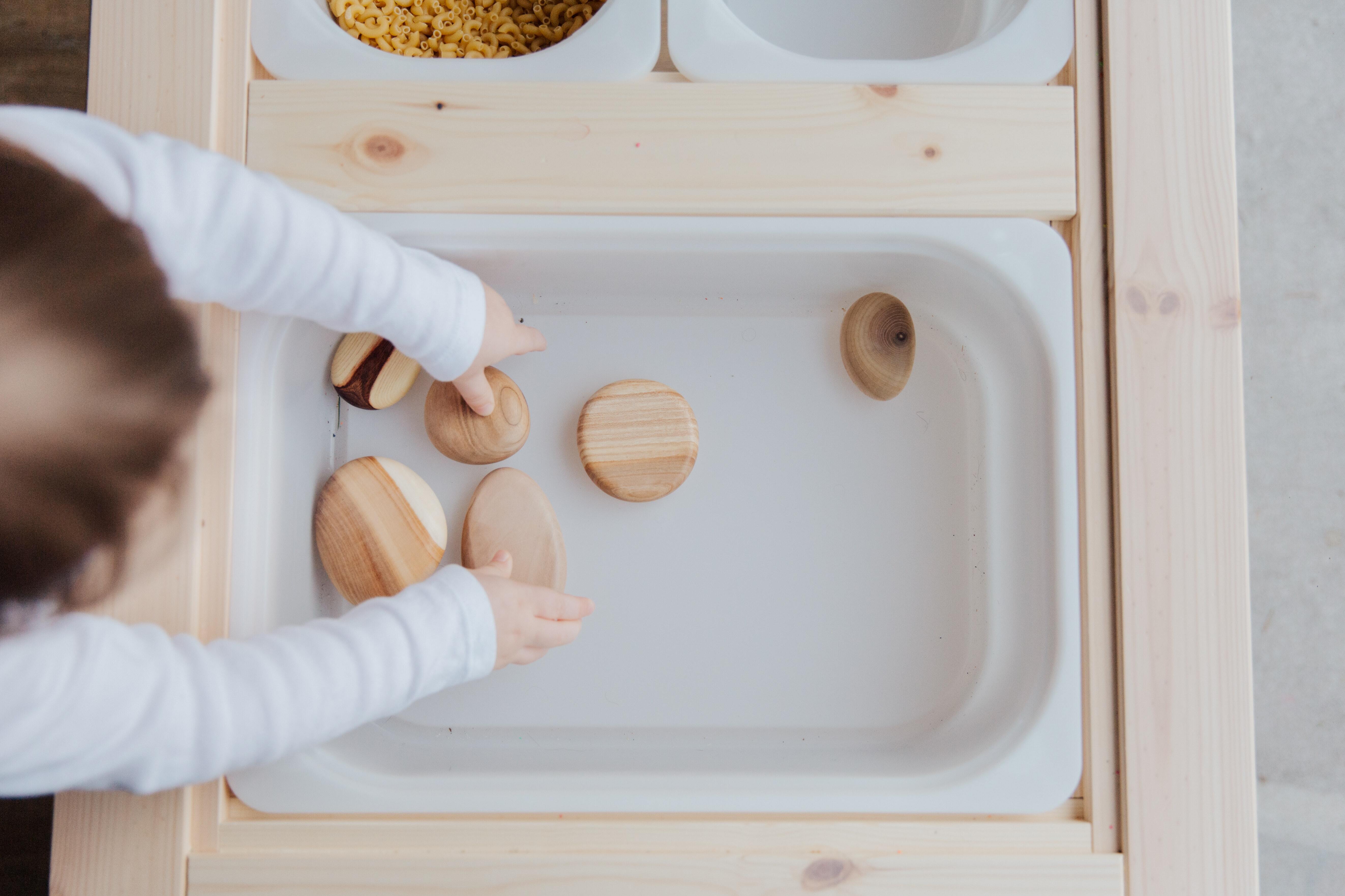 toddler playing with sensory bin