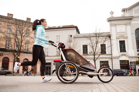 Woman jogging with stroller 