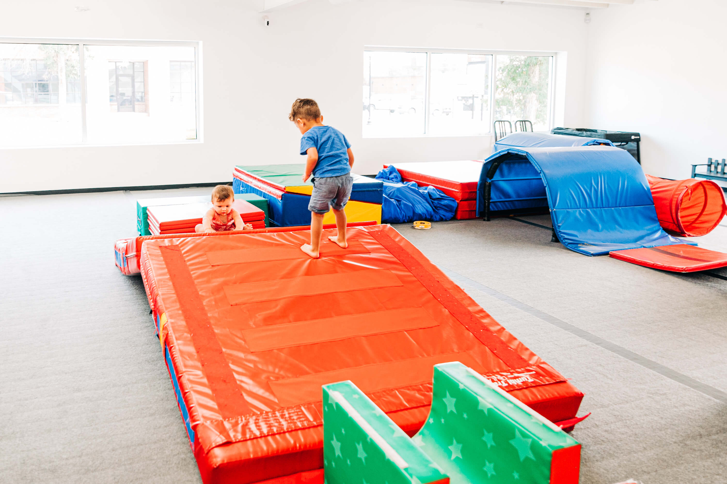 two toddlers playing on an indoor climber