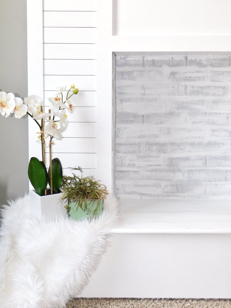 DIY faux fireplace featuring lime washed faux brick panel