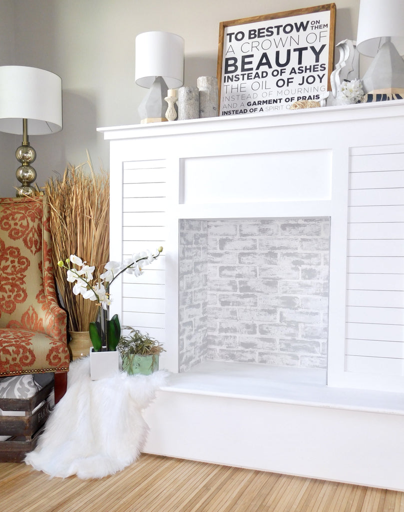 Faux fireplace featuring lime washed faux brick panel