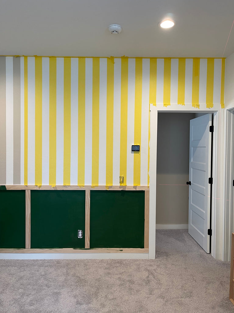 Room painted in stripes Behr Studio Clay