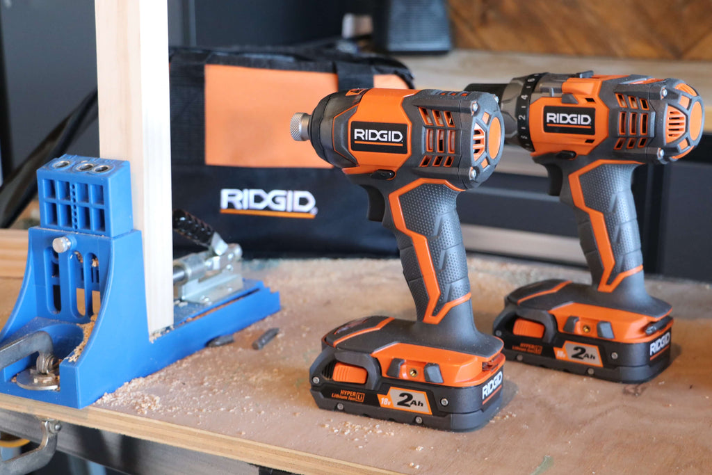 Ridgid 18V Drill/Driver and Impact Driver Combo Kit on a piece of plyboard next to a Kreg Jig K4 Master System