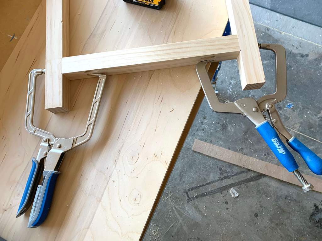 Kreg right angle clamps holding wood together for a diy console table