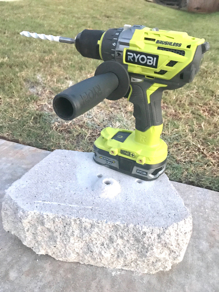 Ryobi Hammer Drill/Driver used to drill a hole into concrete with Bosch Spade bit