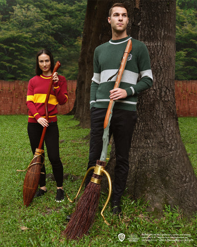 A Male and Female Holding a Firebolt and Nimbus 2000 Replica respectively
