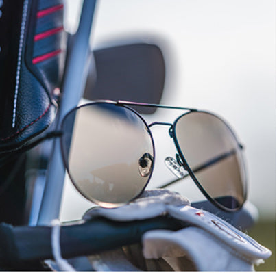 Pair of Aviator style sunglasses on back of golf cart