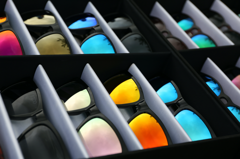A tray of Fuse Lenses Sunglasses in various mirror colors