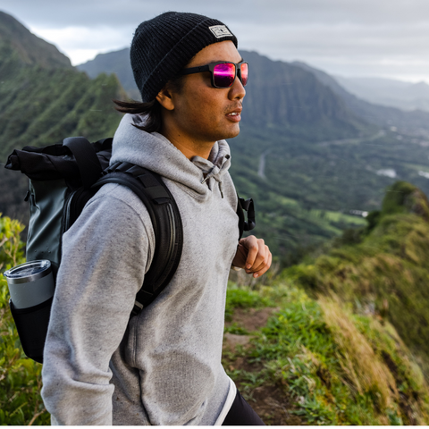 Man wearing sunglasses on top of mountain