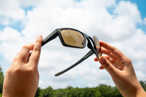 Hands remove lenses from a pair of glasses