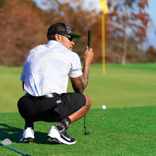 Man wearing AMP sunglasses at a golf course