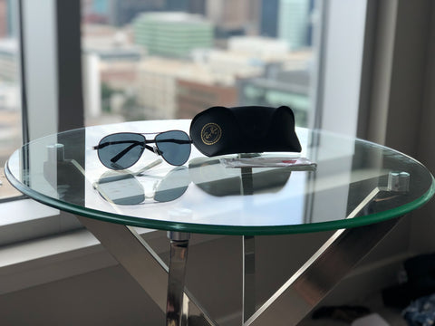 black sunglasses sitting on a table with a case