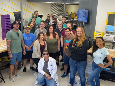 The fuse team stands in the lens lab and poses for a picture
