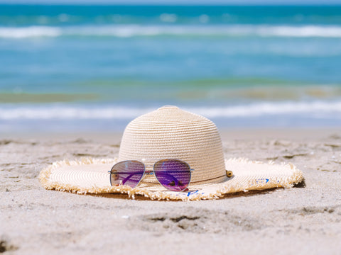 floppy hat with sunglasses on the beach