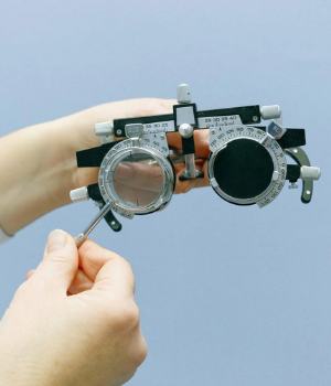 Optician hands hold optical equipment
