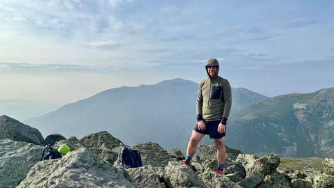 Man Standing on Ridge with Norrona Senja Warm1 Hood