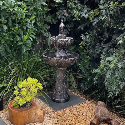 A dark bird bath fountain.