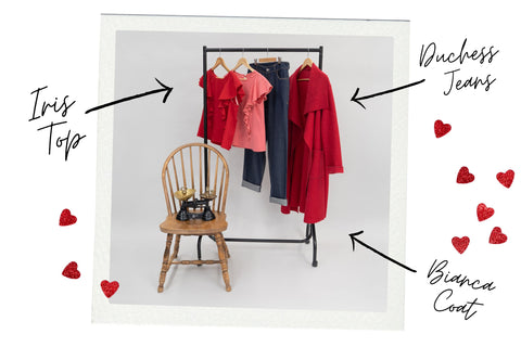 Red coat, jeans and tops hung on a black wardrobe rail