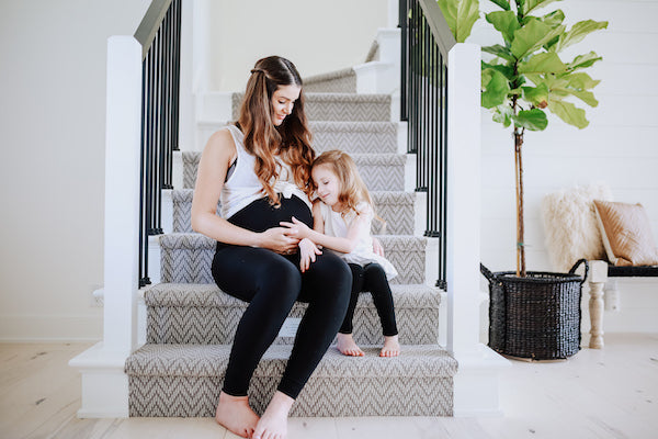 pregnant mom and toddler sitting on stairs