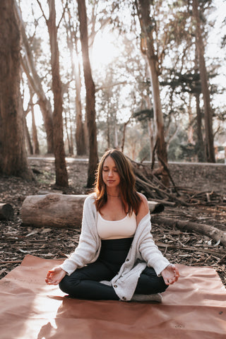 woman in woods sitting