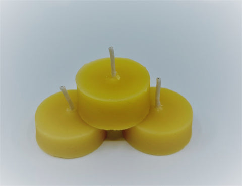 3 teal light beeswax candles stacked in a pyramid formation.
